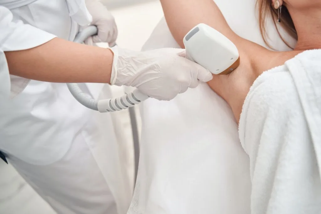 woman getting laser hair removal treatment on her armpit